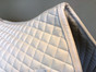 Zoom to View:  White Dressage Saddle Pad with White Trim/Piping Detail Around the Border.  Classy and Elegant!