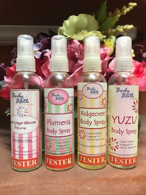 four spray bottles of scented body spray