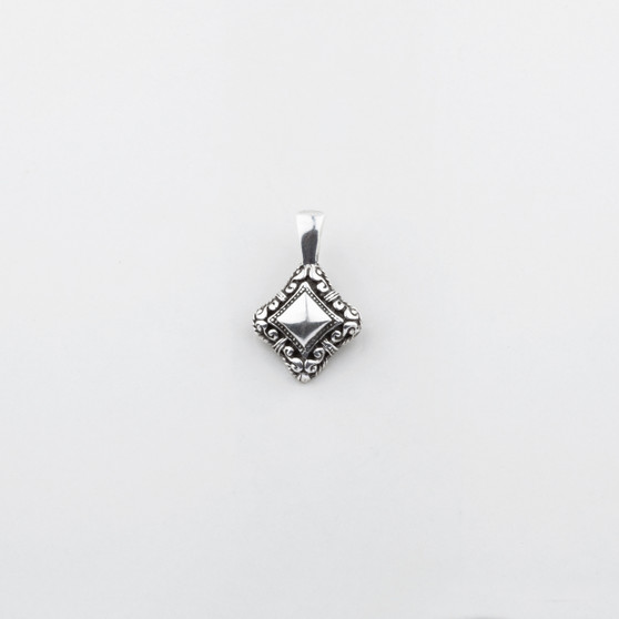 Petite burnished silver pendant with intricate filigree.