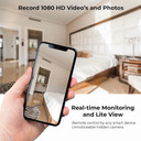 Gio Enteprises Fast Wireless Charger Surveillance Camera With Night Vision, indoor room scene with a person holding a smartphone showing a live view from the hidden security camera.