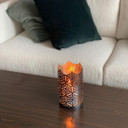 Csc Electronics Candle Holder With 4K UHD WiFi Security Camera Inside and 20 Hr Battery, decorative candle holder on a wooden surface with a lit candle inside, black ornate design with intricate patterns.