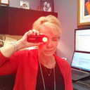 Kjb Security Camera Finder Pro, woman using the device to locate security cameras in an office setting.