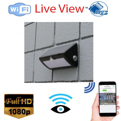 Mini Gadgets WiFi Security Nanny Camera Solor Outdoor Light-HD 1080P Wireless Security Camera with Remote Monitoring, black outdoor light with built-in security camera mounted on a gray brick wall, featuring WiFi connectivity and HD video quality.