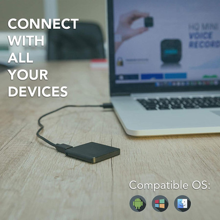 Gio Enterprises Slimmest Voice Activated Recorder with 145 Hours Recording Capacity, MP3 Records, 24 Hours Battery Time, Metal Case, connected to a laptop on a wooden table.