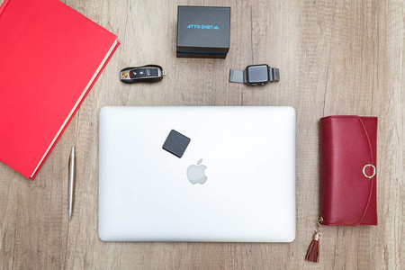 Gio Enterprises Slimmest Voice Activated Recorder with 145 Hours Recording Capacity, MP3 Records, 24 Hours Battery Time, Metal Case, shown on a wooden desk among laptops, notebooks, and accessories.