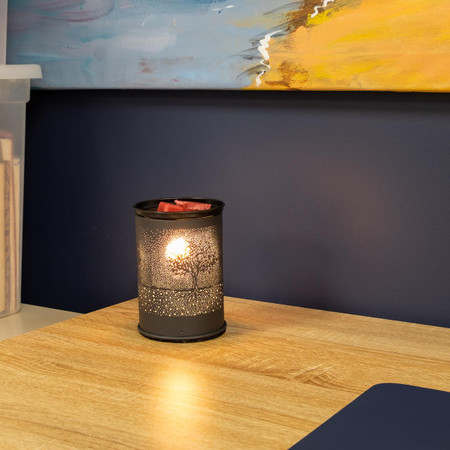 Csc Electronics Wax Warmer with 4K UHD WiFi Security Camera Inside, fully functional, placed on a wooden table with a decorative metal lantern featuring a tree design, interior home decor.