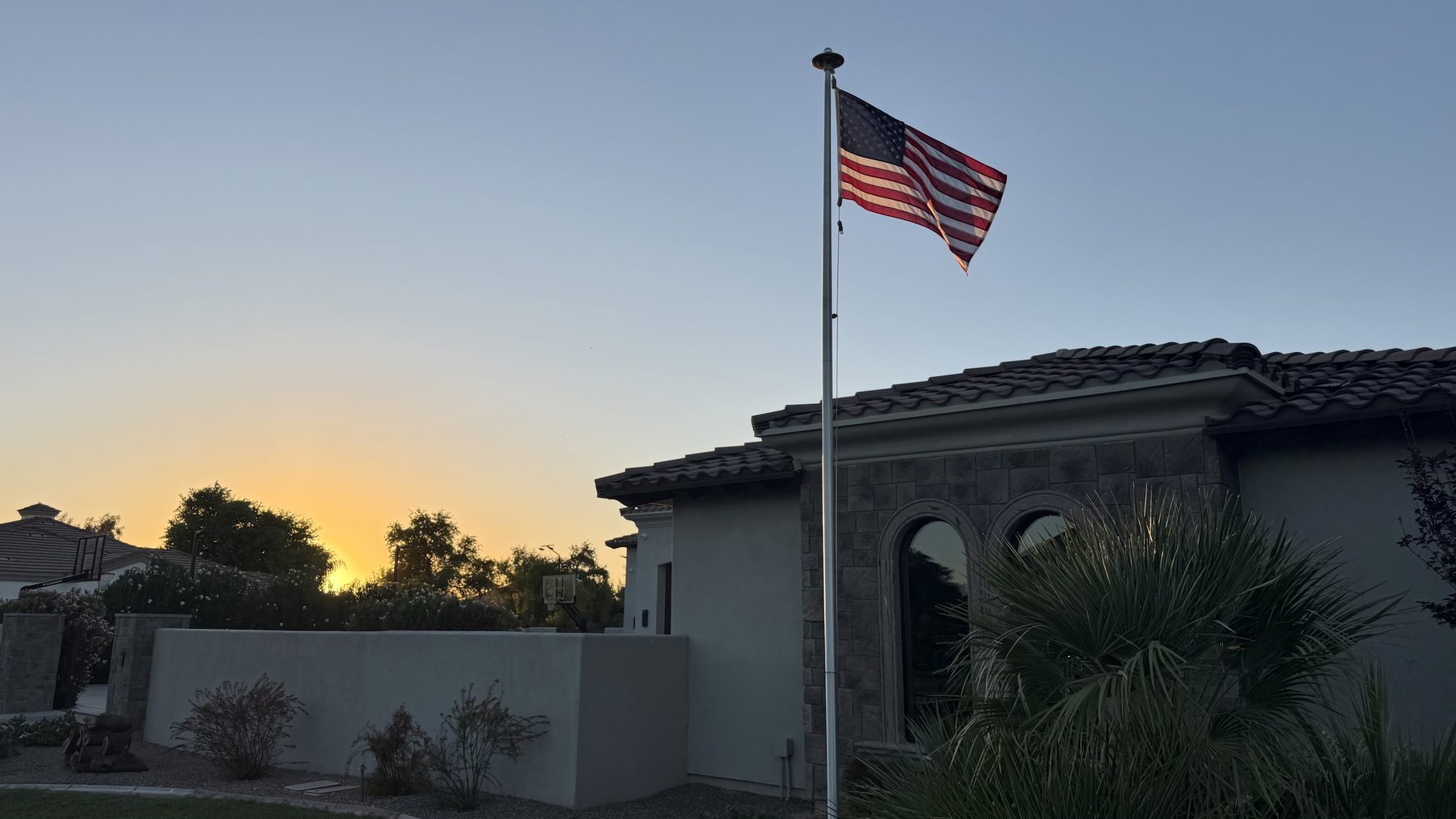 The American flag flying at sunset