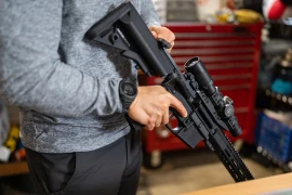 Smith & Wesson M&15® carbine with mounted Leupold® LPVO held at low ready.