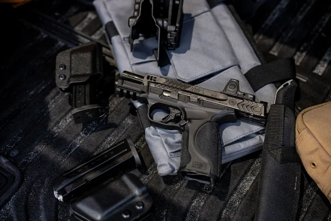 M&P® 2.0 with Trijicon® RMR and magazines atop range bag.