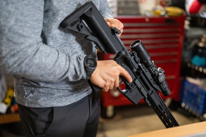 Smith & Wesson M&15® carbine with mounted Leupold® LPVO held at low ready.