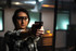 Woman holding a Smith & Wesson pistol aiming down range at a target.
