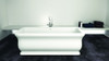 71-in L x 33.5-in W x 25.6-in H Resin Stone Freestanding Bathtub with center drain, in White