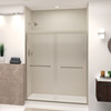 Semi-frameless bypass shower door featuring EXCLUSIVE TruMotion technology in Brushed Stainless frame finish with smooth clear glass texture and modern Sabrina handles 57-3/4-in to 59-in W x 70-in H
