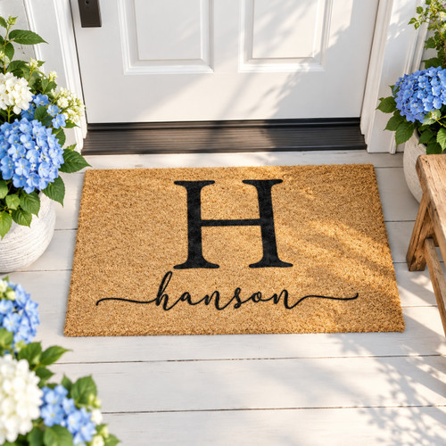 Personalized coir doormat, initial and script name design - on a decorated front porch