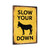 Vintage-Style "Slow Your Donkey Down" Sign - Rustic Yellow Background With Playful Warning Message 8x12