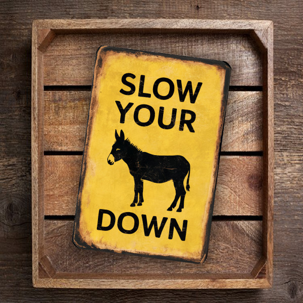 Vintage-Style "Slow Your Donkey Down" Sign - Rustic Yellow Background With Playful Warning Message 8x12