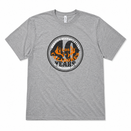 Front view of the Los Cazadores 40 Years Short Sleeve Tee in heather gray featuring the commemorative 40 Years Hunting Headquarters graphic on a white background.