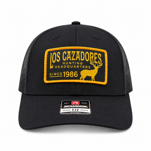 Front view of Los Cazadore Hunting Headquarter Patch Richardson 112 Cap in Black with Black Meshing on white background.