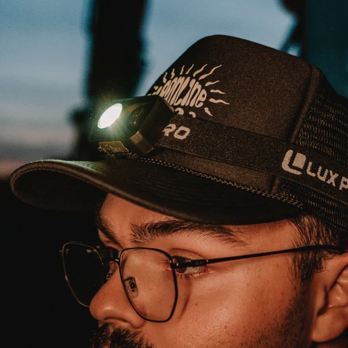 Man wearing the LuxPro LP342 headlamp on a cap