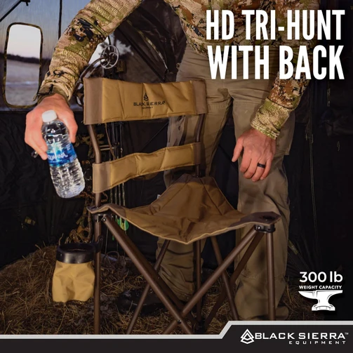 Hunter setting a water bottle beside the HD Tri-Hunt chair inside a ground blind