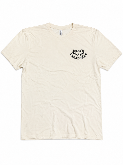 Front view of the Los Cazadores 40 Years Short Sleeve Tee in cream featuring the Los Cazadores logo on the left chest on a white background.
