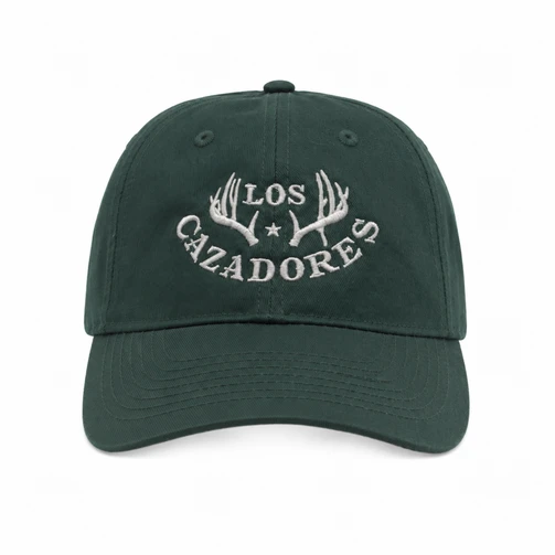Front view of the Los Cazadores forest green cap with light horn logo embroidery on a clean white background.