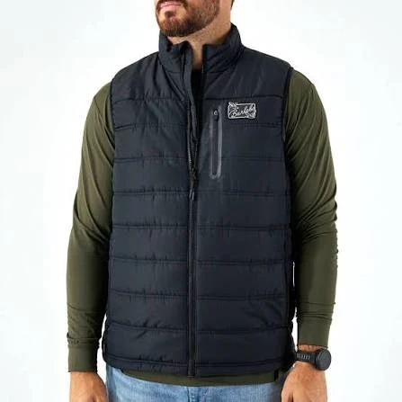 Man wearing the Burlebo puffer vest in black over an olive long sleeve, front view