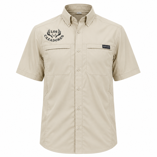 Front view of a khaki Los Cazadores short-sleeve button-down performance shirt displayed on a ghost mannequin against a white background. Features embroidered black Los Cazadores antler logo on the left chest, vented mesh side panels, dual chest pockets, button-front closure, and lightweight outdoor fabric.