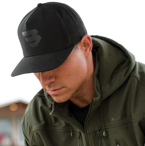Man in a green jacket wearing the Burlebo black Flying B performance cap