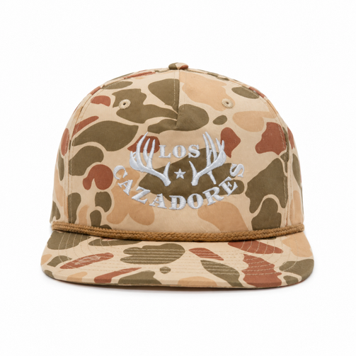 Front view of the Los Cazadores tan camo rope cap with white horn logo embroidery on a clean white background.