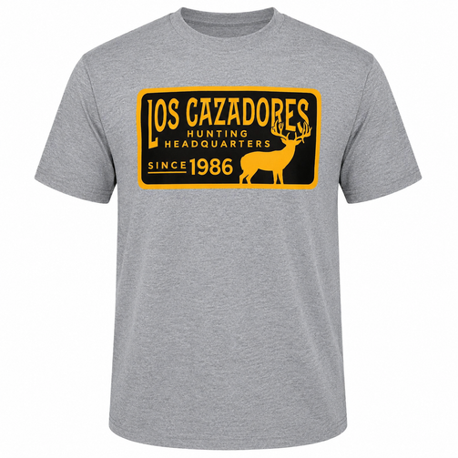 Front view of a heather gray Los Cazadores short-sleeve graphic T-shirt laid flat. Features a large vintage-style black and gold chest graphic with a deer silhouette and the text "Los Cazadores Hunting Headquarters Since 1986," creating a classic hunting-inspired design.