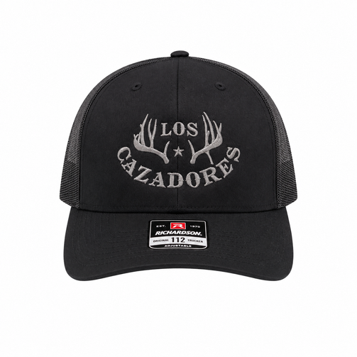 Front view of the Los Cazadores black mesh-back cap Size XL with white horn logo embroidery and brim sticker on a clean white background.