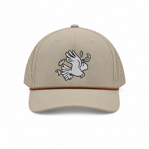 Front view of the tan Los Cazadores performance rope cap with bird embroidery and rust rope detail on a clean white background.