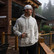 Man wearing the Burlebo vintage washed hoodie in classic deer camo on a cabin deck