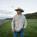 Man in a cowboy hat wearing the Burlebo vintage washed hoodie in drifter camo in an open field