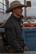 Cowboy in a felt hat at a rodeo arena wearing the Ferrell CORE long sleeve pearl snap shirt in Grey, side view