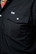 Close-up of the Ferrell CORE long sleeve shirt in Black showing the flap chest pocket, pearl snaps and Ferrell logo tab