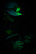 Person wearing the Cyclops Force XP headlamp on a cap with green light on