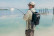 Angler wading the flats with a Turtlebox Ranger speaker on his backpack