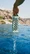 Hand lifting a River Rock Turtlebox Ranger speaker out of the water by its handle