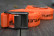 Close-up of an orange Turtlebox tie-down strap and its metal cam buckle
