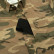 Close-up of The San Juan camo Poncho Original shirt showing a phone stored in the hidden zippered chest pocket