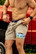 Man wearing the Burlebo men's athletic shorts in khaki with a palm tree print liner