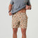 Model lifting his shirt to show the elastic waistband on the Burlebo men's everyday short in a tan camo print