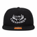 Front view of a black Los Cazadores rope hat with white embroidered logo and flat brim on a white background.