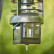 Moultrie Universal Feed Hub Unit installed on a feeder, showing the device mounted beneath the feed mechanism in an outdoor setup.