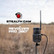 Stealth Revolver Pro 2.0 cellular game camera mounted outdoors in a field with branding shown beside the camera setup.