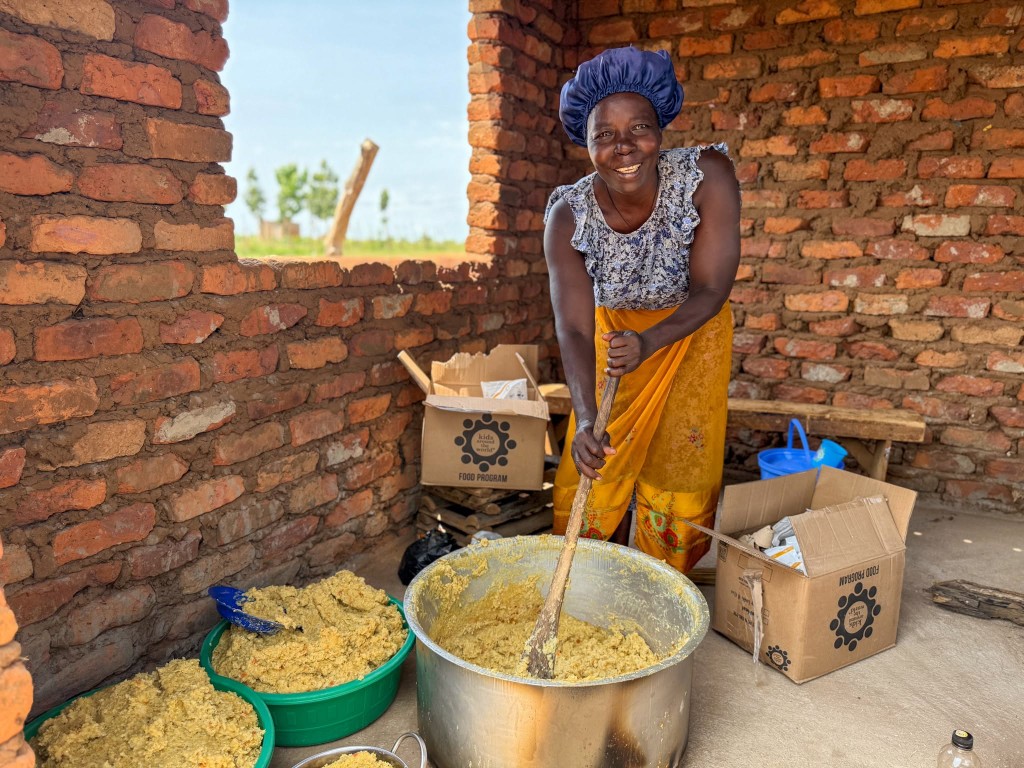 A community partner preparing OneMeal meals with Kids Around the World food program supplies