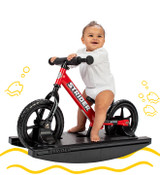 Baby sitting on a red 2-in-1 Rocking Bike with yellow digital doodles surrounding them