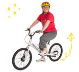 A young adult sits on the 20x Sport bike in a studio setting
